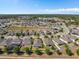 Aerial view of a single-Gathering home in a residential neighborhood with lush greenery and community amenities at 944 Flyer St, Orange City, FL 32763