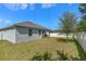 Spacious backyard features a lush lawn and a white fence, offering privacy and room for outdoor activities at 944 Flyer St, Orange City, FL 32763