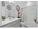 Well-maintained bathroom with gray vanity, decorative wall art, and shower-tub combo at 944 Flyer St, Orange City, FL 32763