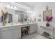 Bright bathroom featuring double sinks, vanity, a large mirror, and stylish decor at 944 Flyer St, Orange City, FL 32763