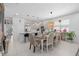 Open-concept layout featuring a dining table adjacent to a kitchen with an island and modern pendant lighting at 944 Flyer St, Orange City, FL 32763