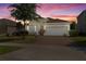 Charming one-story home featuring a two-car garage, brick driveway, and stone facade accents at 944 Flyer St, Orange City, FL 32763