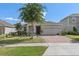 Attractive single-Gathering home with a manicured front yard and a brick driveway, complemented by stone design features at 944 Flyer St, Orange City, FL 32763