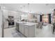 Stylish kitchen with white cabinets, an island, and stainless steel appliances, open to dining area at 944 Flyer St, Orange City, FL 32763