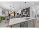 Stylish kitchen island with a sink, stainless steel dishwasher, and pendant lighting overlooking dining area at 944 Flyer St, Orange City, FL 32763