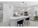 Modern kitchen with white cabinets, stainless steel appliances, and a large center island with seating at 944 Flyer St, Orange City, FL 32763
