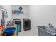 Functional laundry room with washer, dryer, utility sink, and storage solutions at 944 Flyer St, Orange City, FL 32763