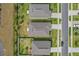 Aerial view of three well-maintained houses, showing their rooftops and manicured lawns and landscaping at 1030 Alabaster Way, Deltona, FL 32725