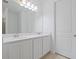 Bright bathroom with double sinks, quartz countertops, and modern lighting at 1030 Alabaster Way, Deltona, FL 32725