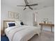 Nicely staged bedroom with a decorative wooden table, bed, and ceiling fan at 1030 Alabaster Way, Deltona, FL 32725
