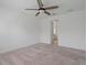 A carpeted, empty room shows the potential of this spacious bedroom at 1030 Alabaster Way, Deltona, FL 32725