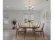 Bright dining room with neutral decor, chandelier, and large windows at 1030 Alabaster Way, Deltona, FL 32725