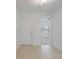 Bright entryway with neutral tile flooring and white walls, leading into a carpeted living space at 1030 Alabaster Way, Deltona, FL 32725