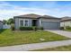 Beautiful one-story home featuring a well-maintained lawn and gray exterior with a two-car garage at 1030 Alabaster Way, Deltona, FL 32725