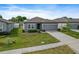 Single-story home with a well-maintained lawn and inviting curb appeal at 1030 Alabaster Way, Deltona, FL 32725