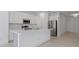 This modern kitchen features white cabinets, stone countertops and stainless appliances at 1030 Alabaster Way, Deltona, FL 32725
