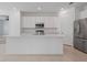 This modern kitchen features white cabinets and stainless steel appliances at 1030 Alabaster Way, Deltona, FL 32725