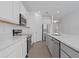 This bright kitchen features white cabinets, stone countertops and stainless appliances at 1030 Alabaster Way, Deltona, FL 32725