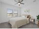 A sunlit main bedroom with a ceiling fan, plush carpet, and tranquil decor for relaxation at 1030 Alabaster Way, Deltona, FL 32725