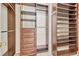 Spacious walk-in closet featuring custom dark wood shelving and drawers for optimal organization at 1162 Lebanon Ct, Sanford, FL 32771