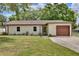 Charming single-story home featuring a well-maintained lawn and a one-car garage at 1179 Shadow Run Dr, Lakeland, FL 33813