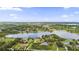 Panoramic aerial showcases a serene lake surrounded by lush greenery and beautiful homes at 13638 Sunset Lakes Cir, Winter Garden, FL 34787