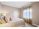 Cozy bedroom featuring neutral walls, a window with curtains, and comfortable bedding at 13638 Sunset Lakes Cir, Winter Garden, FL 34787