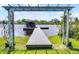 Lakeside view of a charming dock with a covered gazebo and beautiful waterfront scenery at 13638 Sunset Lakes Cir, Winter Garden, FL 34787