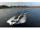 Aerial of waterskiing on the lake, showcasing the recreational lifestyle of the community at 13638 Sunset Lakes Cir, Winter Garden, FL 34787