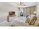 Comfortable main bedroom with decorative pillows, ceiling fan, and large window with curtain at 13638 Sunset Lakes Cir, Winter Garden, FL 34787