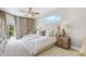 Tranquil main bedroom with plush bedding, neutral tones, and sliding door access to outdoor pool at 13638 Sunset Lakes Cir, Winter Garden, FL 34787