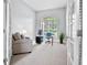 Bright home office features a large window, neutral walls, and a comfortable armchair at 13638 Sunset Lakes Cir, Winter Garden, FL 34787