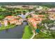 Stunning aerial view of a community featuring a mix of commercial and residential buildings, water features, and a golf course at 1390 Harbor Ridge Dr, Kissimmee, FL 34759