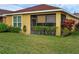 Back exterior of home featuring a screened in porch at 1390 Harbor Ridge Dr, Kissimmee, FL 34759