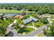 Beautiful aerial view of the property showcasing the manicured landscaping and proximity to the water and golf course at 203 Prestwick Dr, New Smyrna Beach, FL 32168
