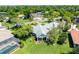 Real estate aerial view of a suburban home with a pool, well-kept lawn, and mature trees at 203 Prestwick Dr, New Smyrna Beach, FL 32168