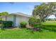 Manicured backyard with a healthy green lawn and privacy landscaping and view to pond at 203 Prestwick Dr, New Smyrna Beach, FL 32168
