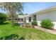 Beautiful backyard featuring a stone path, patio, mature trees, and lush grass at 203 Prestwick Dr, New Smyrna Beach, FL 32168