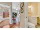 Bright bathroom featuring tile floors, a bathtub and an entrance to the dining room at 203 Prestwick Dr, New Smyrna Beach, FL 32168