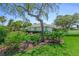 Well-maintained home exterior with lush landscaping, mature trees, and vibrant flower beds at 203 Prestwick Dr, New Smyrna Beach, FL 32168