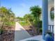 Charming pathway leading to the home's entrance, adorned with plants and decorative landscaping at 203 Prestwick Dr, New Smyrna Beach, FL 32168