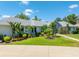 Picture-perfect front exterior featuring tropical landscaping and a beautiful home design at 203 Prestwick Dr, New Smyrna Beach, FL 32168