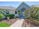 Lovely front exterior with a walkway to the front door and manicured flowerbeds at 203 Prestwick Dr, New Smyrna Beach, FL 32168