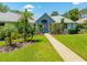 Attractive front exterior showcasing mature landscaping, and well-maintained lawn at 203 Prestwick Dr, New Smyrna Beach, FL 32168