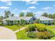 Beautiful home with meticulously landscaped front yard and mature tropical plants at 203 Prestwick Dr, New Smyrna Beach, FL 32168