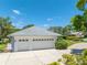 Detached white three-car garage with ample parking space and well-manicured landscaping at 203 Prestwick Dr, New Smyrna Beach, FL 32168