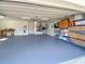 Spacious three-car garage with epoxy floors, modern utilities, and ample storage space at 203 Prestwick Dr, New Smyrna Beach, FL 32168