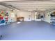 Spacious garage with painted floors and ample room for storage and hobbies at 203 Prestwick Dr, New Smyrna Beach, FL 32168