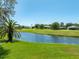 Scenic view of a golf course and pond, showcasing the property's tranquil backyard setting at 203 Prestwick Dr, New Smyrna Beach, FL 32168