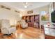 Comfortable living room featuring hardwood floors, bookshelves and two leather recliner chairs at 203 Prestwick Dr, New Smyrna Beach, FL 32168